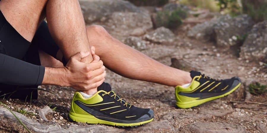 Runner holding ankle after injury
