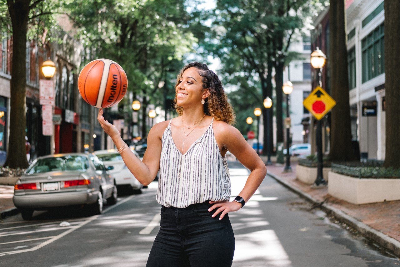 Kristina King Basketball Player with Basketball on finger standing in the road