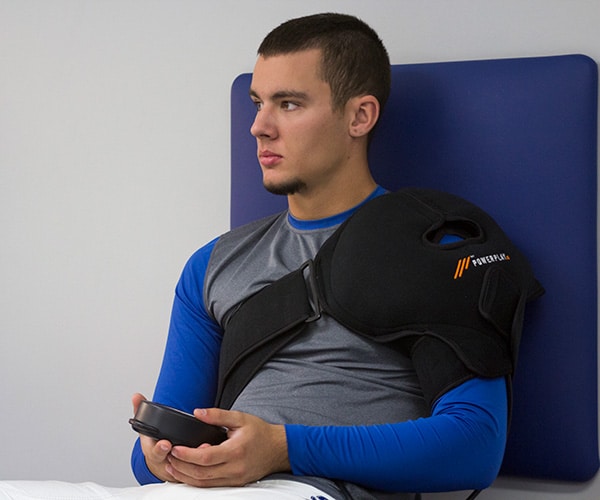athlete recovering with PowerPlay shoulder compression wrap